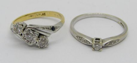 18ct platinum set three stone diamond crossover ring with small sapphires to shoulders, size J/K,