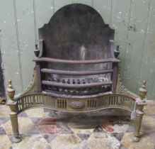 A Georgian style cast iron and brass fire basket with serpentine front 61 cm (full width) together