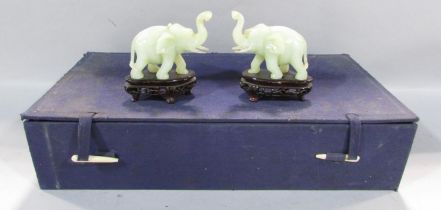 A pair of Chinese carved hard stone / bowenite jade elephants, one with restored break to trunk in