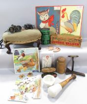 A box of miscellaneous effects, including a needlepoint footstool, vintage cardboard infants