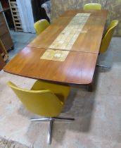 A mid 20th century G plan teakwood extending drop leaf table , the central section enclosing ceramic