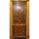 A good quality reproduction side cabinet in pollard oak enclosed by three drawers and brush slide,