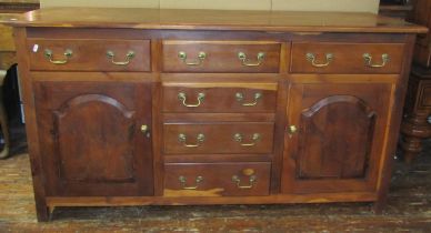 A solid yew wood dresser base in the Georgian style, the T shaped arrangement of six drawers