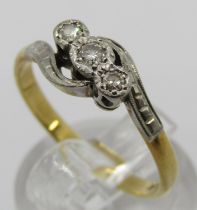 18ct three stone diamond crossover ring with platinum setting, size P/Q, 2.9g