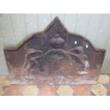 A cast iron fire back of stepped arched form with raised relief armorial detail 69 cm high x 89 cm
