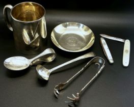 A mixed collection of silver items to include pen tray, christening mug, a centenary dish, a sauce