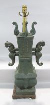 A Chinese Archaic bronze urn with mythical animal arms and cover, with later electrical lamp
