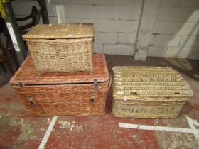 A large wicker laundry basket with side carrying handles, 54cm high x 90cm x 55cm, together with two