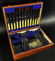 A small oak canteen of cutlery complete for six settings, together with a cased set of fish knives