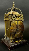 A small 19th century lantern clock of usual form with single train fusee movement, set on a square