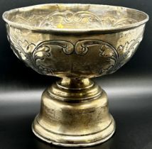 A late Victorian silver sugar bowl decorated with a rural milking scene, raised on three lion mask