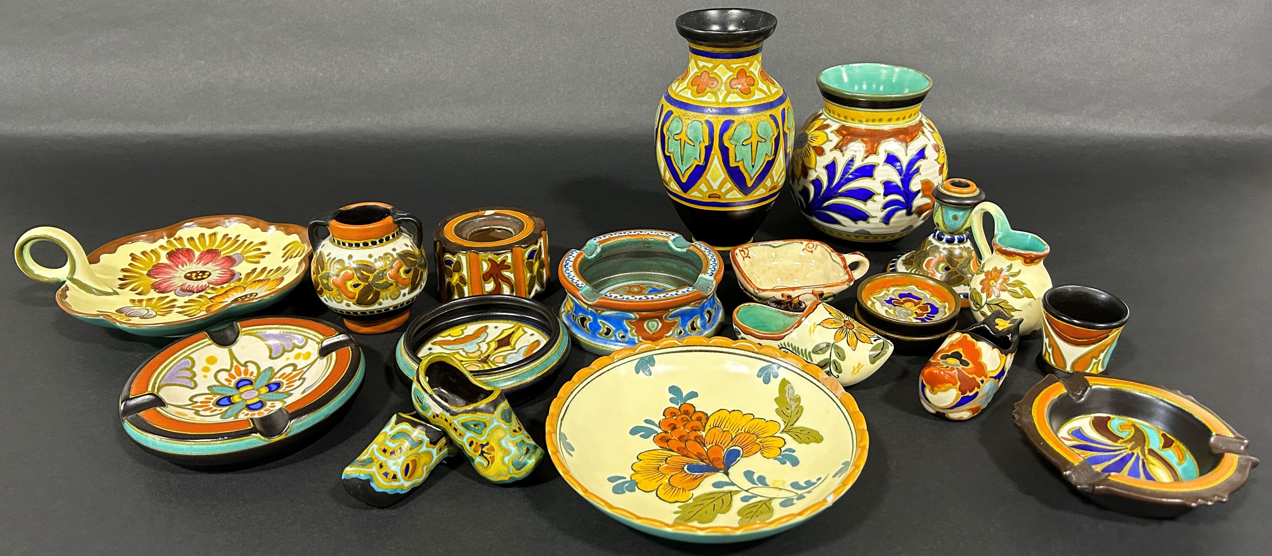 A collection of traditional Gouda ware comprising vases, dishes, small ornamental pieces and seven