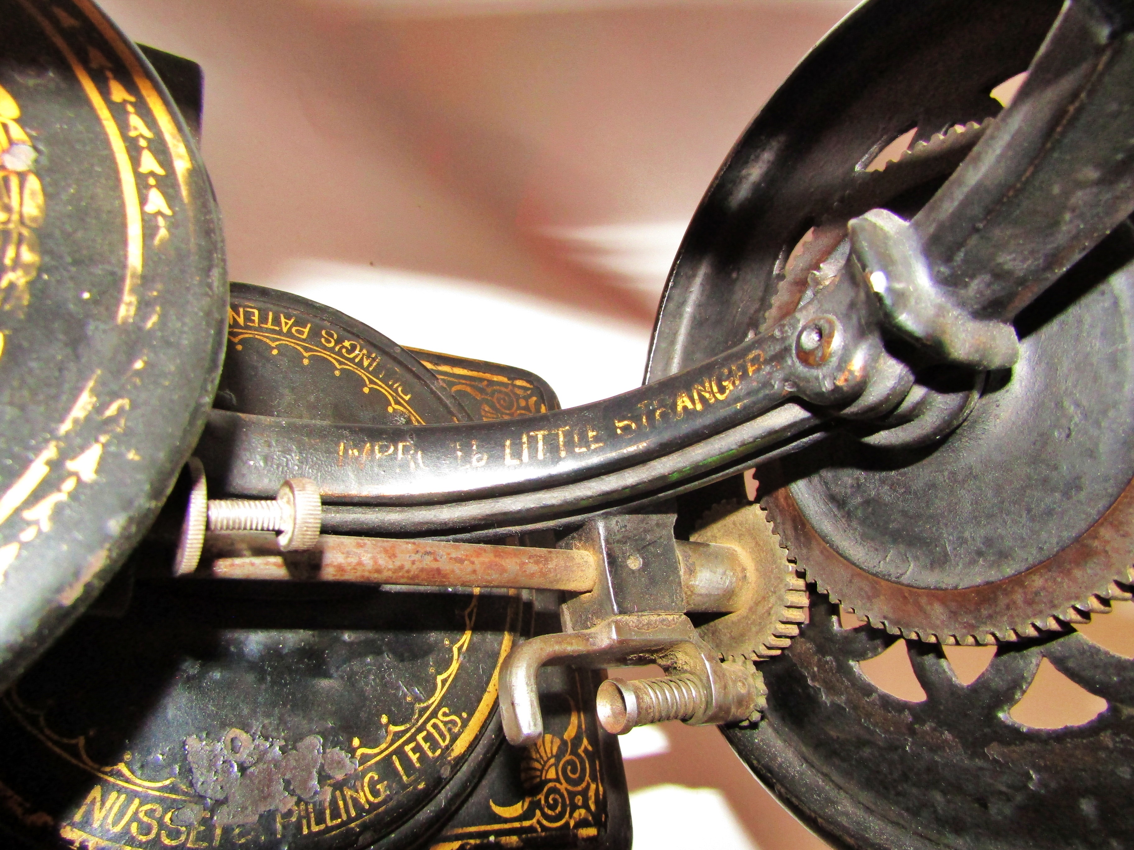 A scarce Nussey & Pilling 'Little Stranger' Victorian sewing machine with gilt decoration, on metal - Image 12 of 13