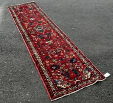 North West Persian Mahal Runner with an all over floral pattern on a red ground, 330 x 80cm