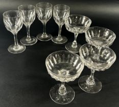 Ten cut glass Champagne bowls with facetted stems, together with six near matching red wine