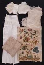 Small collection of early 20th century textiles including an embroidered panel featuring woodland