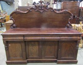 A Victorian mahogany sideboard, the shallow inverted base enclosing four arched moulded panelled