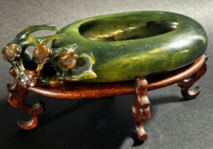 A Chinese translucent spinach green bowenite jade brush washer, of peddle form carved with flowering