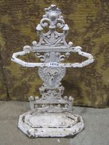 A Victorian iron stick stand with rams mask and geometric detail with drip tray and lozenge mark