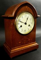 Edwardian oak lancet shaped mantle clock, the case with marquetry inlay, with eight day striking