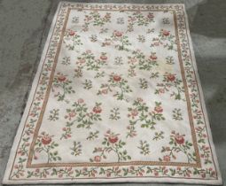 Two Aubusson style woven wool rugs, one with pink rose decoration, the other with panelled