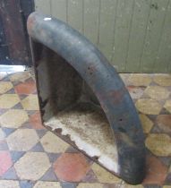 An old heavy gauge cast iron wall mounted corner stable trough with enamelled interior and over