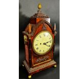 A Regency mahogany bracket clock, the case of Gothic design, enclosing a convex painted dial with
