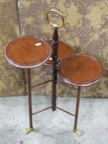 An unusual Edwardian mahogany and brass three tier cake stand supported by a central turned stem and