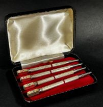 A cased set of four sterling silver propelling bridge pencils