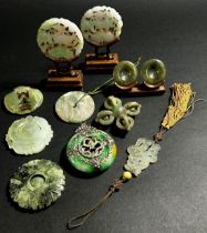 A group of nine Chinese carved jadeite / bowenite jade / hardstone Bi discs and pendants to