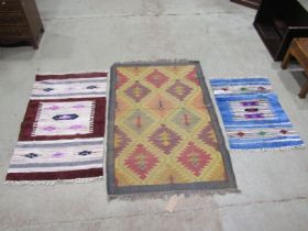 A Kilim carpet with diagonal trellis pattern, 150cm x 98cm and two kilim type mats 125cm x 72cm,