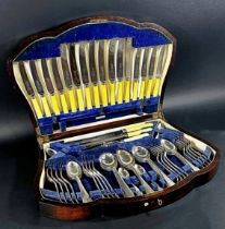 A 1930’s oak canteen of cutlery complete for eight settings, bone handled knives and carving set, (