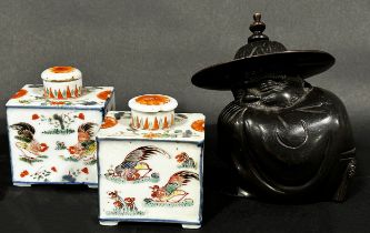 A pair of Chinese porcelain tea caddies with mushroom shaped stoppers, painted detailing showing