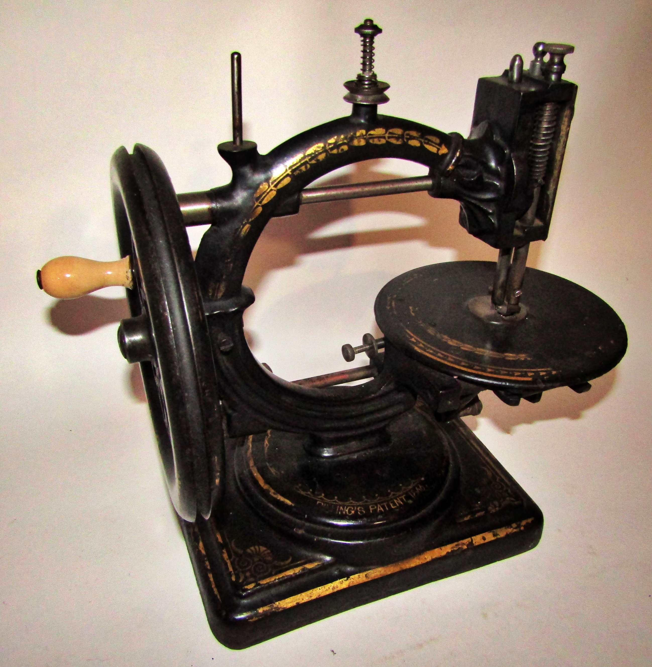 A scarce Nussey & Pilling 'Little Stranger' Victorian sewing machine with gilt decoration, on metal - Image 7 of 13