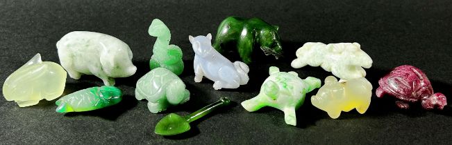 A small collection of Chinese carved hardstone, jadeite and quartz figures to include a cat eating a