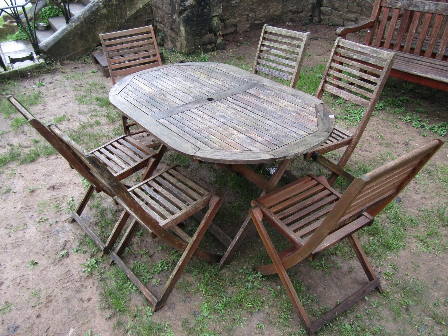 A weathered contemporary teak garden table of oval form with slatted top, raised on X framed - Image 9 of 9