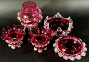 Ten Victorian Cranberry glass items to include water jugs, milk jugs, crimped edged sugar bowls etc.