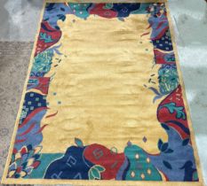 An Art Deco style carpet with a stylised border on a mustard ground together with a similar rug with