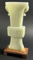 A Chinese archaistic style carved pale mutton fat jade / hardstone vase, of tapering flared form,