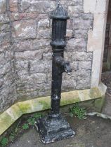 An overpainted composition stone water feature in the form of a Victorian cast iron hand lever