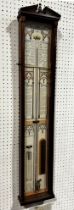 An Admiral Fitzroy barometer, the printed back with Gothic tracery outline, set within a mahogany