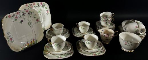 A Delphine china tea service for ten with hand painted trailing floral detail