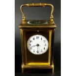 A 19th century French carriage clock with enamelled dial and eight day striking movement,