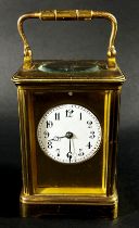 A 19th century French carriage clock with enamelled dial and eight day striking movement,