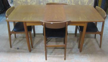 A Mid 20th century teakwood extending dining table together with four chairs