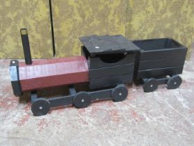 A rustic wooden scratch built model of a steam engine and tender, with painted finish