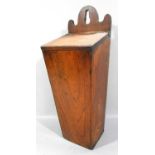 A 19th century elm candle box with a sound hinge with a selection of modern candles, 42 cm high.