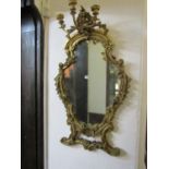 An unusual 19th century girandole mirror, the shield shaped gilt frame with scrolling acanthus and