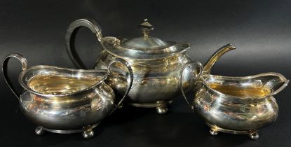 A three piece silver tea service, Sheffield 1925 and an earlier sugar bowl, 1915, both made by Atkin