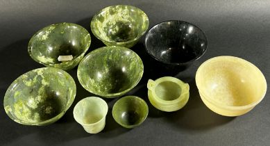 A collection of Chinese bowenite jade / hardstone bowls pf varying size / form to include a